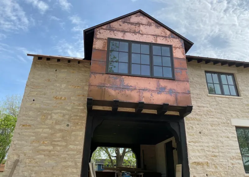 Copper metal panel facade on a stone building for Metal Roof Coating in Dalhart